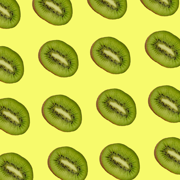 pattern of sliced kiwis isolated on yellow background for print - Photo, Image
