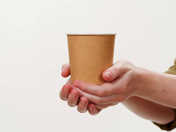 disposable coffee paper eco friendly cup in hand isolated on white background 2021 - Photo, image