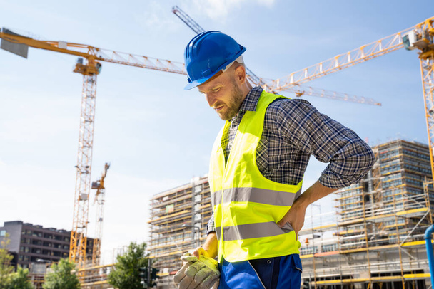 Engineer With Back Pain Injury After Accident At Construction Site - Valokuva, kuva