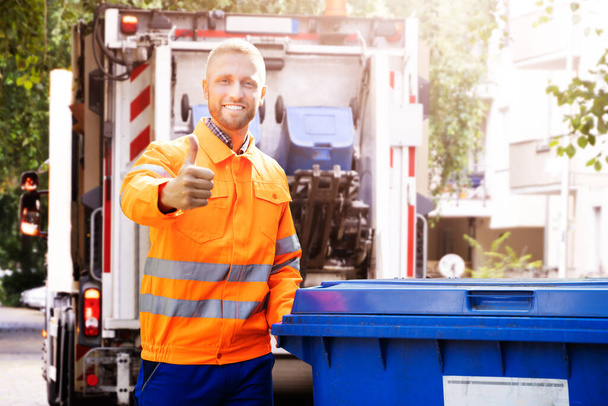 Garbage Removal Man Doing Trash And Rubbish Collection - 写真・画像