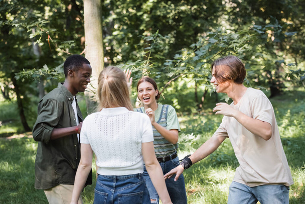 Positive interracial teen friends having fun outdoors  - Valokuva, kuva