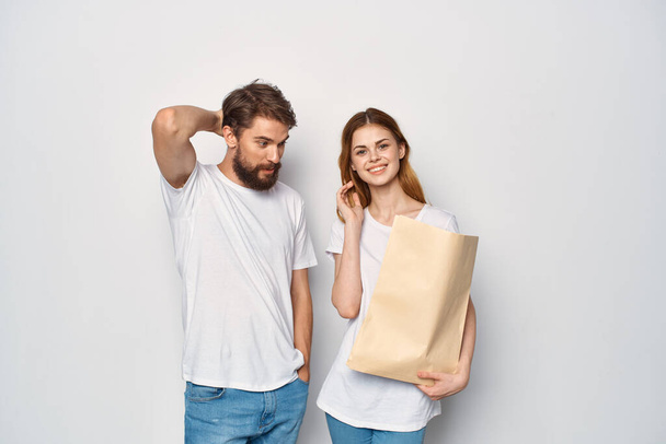 Mann und Frau in weißen T-Shirts Papiertüten einkaufen - Foto, Bild