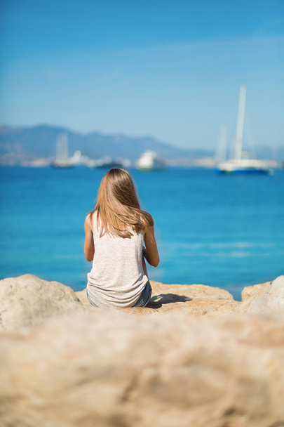 Young girl enjoying her vacation by the sea - Фото, зображення