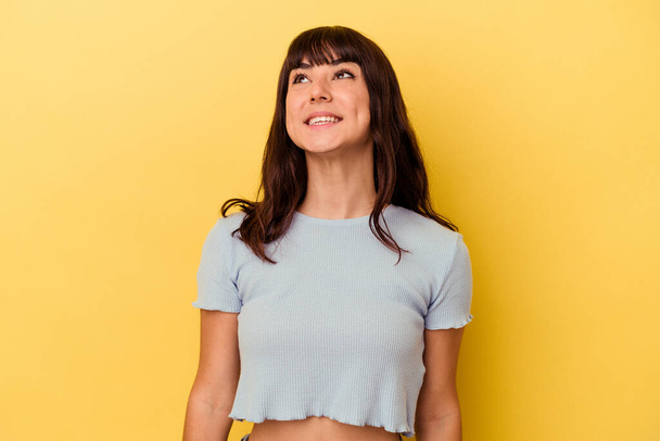 Young caucasian woman isolated on yellow background relaxed and happy laughing, neck stretched showing teeth. - 写真・画像