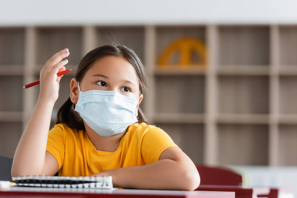 asian girl in medical mask raising hand during lesson - Photo, Image
