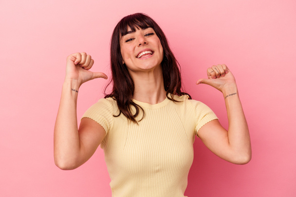 Young caucasian woman isolated on pink background feels proud and self confident, example to follow. - 写真・画像