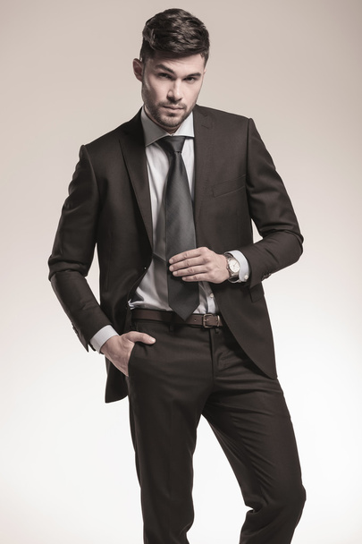 sexy young business man holding his tie - Фото, изображение