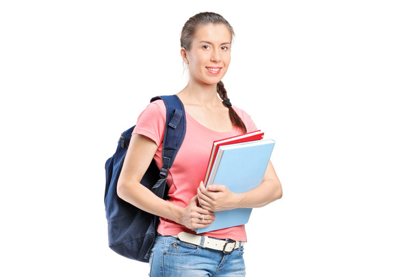 Schoolgirl with backpack holding notebooks - Fotografie, Obrázek