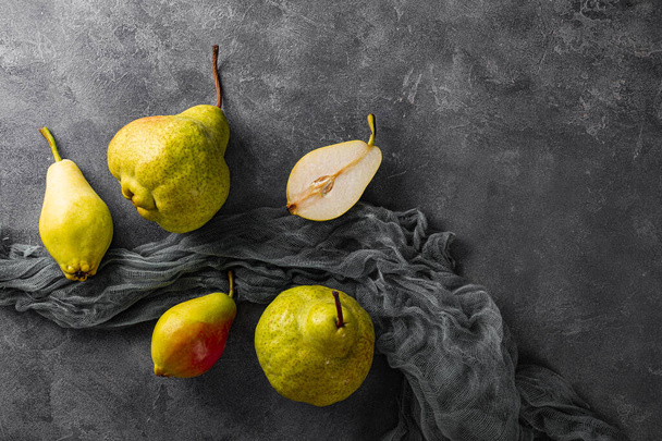 Several ripe pears on gray background top view, trending ugly fruits - Фото, изображение