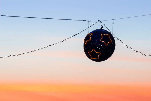 Suspended christmas street lights at sunset - Photo, Image