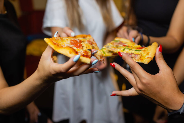 Group of people eating delicious pizza. - Фото, изображение