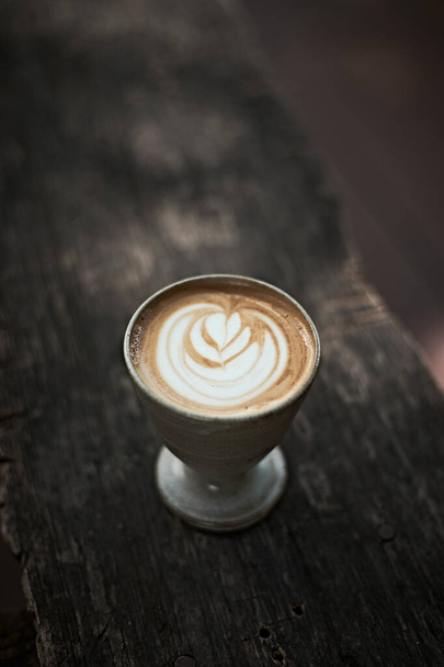 Selective focus cup of hot latte art coffee,focus at white foa - Fotó, kép
