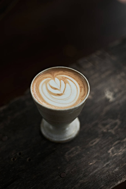 Selective focus cup of hot latte art coffee,focus at white foa - Fotó, kép