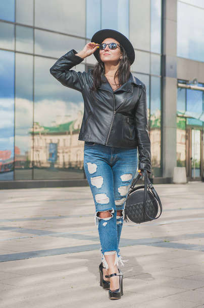 Beautiful young happy woman on the mirror wall of city building background - Foto, imagen