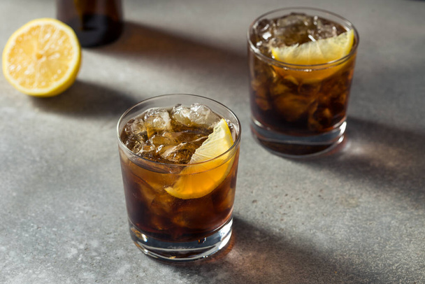 Boozy Cold Bourbon Whiskey and Cola with Lemon - Photo, image