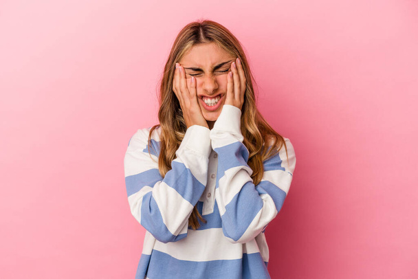 Young blonde caucasian woman isolated on pink background whining and crying disconsolately. - Photo, Image