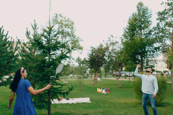 Młoda para dorosłych gra w badmintona w parku - Zdjęcie, obraz