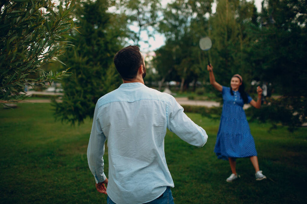 Young adult couple playing badminton in the park - Photo, Image