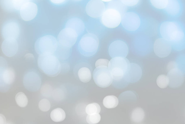 A closeup white and blue bokeh lights background - great for wallpaper - Photo, image