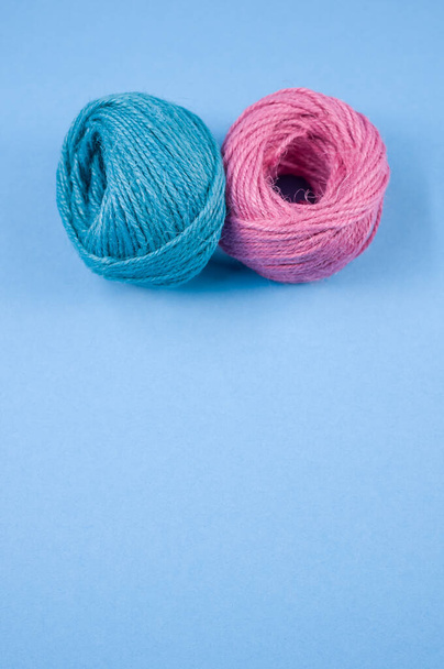 A top view of a colorful thread rope yarn on a blue background - Φωτογραφία, εικόνα
