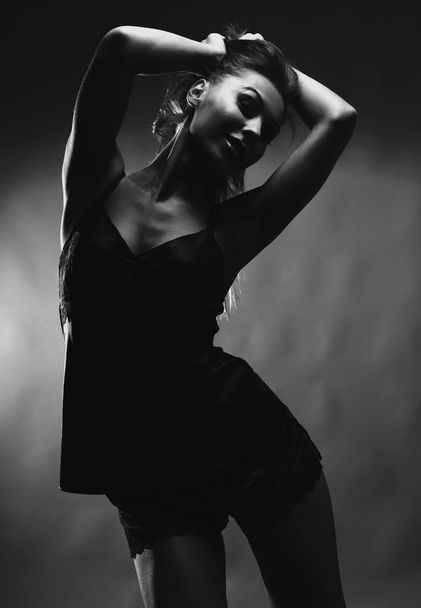 Sexy woman posing over dark background. - Valokuva, kuva