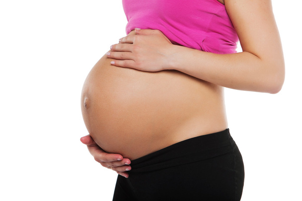 Close up of a cute pregnant belly - Foto, immagini