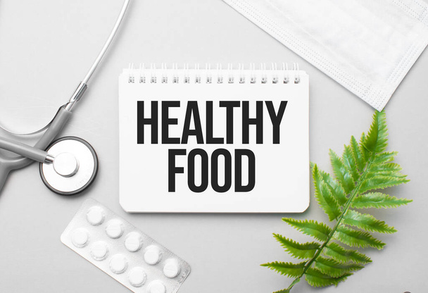 Healthy Food word on notebook,stethoscope and green plant - Foto, Bild