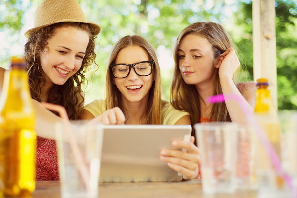 Girls having fun with tablet - Foto, afbeelding