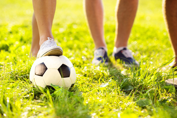 Feet and football ball - Foto, afbeelding