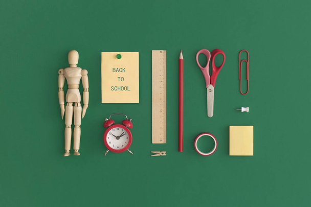 School stationery on a green background. Top view with copy space. Flat lay. Back to school concept. - 写真・画像