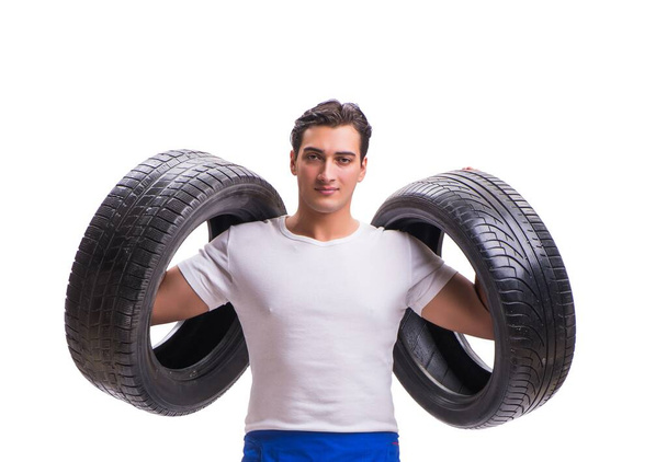 Handsome tyre repairman isolated on white - Foto, Imagem