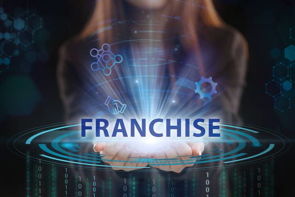 Business, Technology, Internet and network concept. Young businessman working on a virtual screen of the future and sees the inscription: Franchise - Photo, image