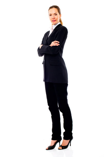 Young businesswoman standing with arms crossed - Фото, изображение