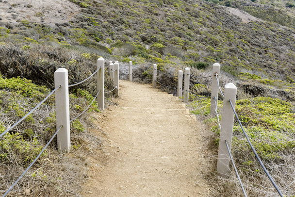 Trail winding downhill at Milagra Ridge. San Mateo County, California, USA. - Photo, Image