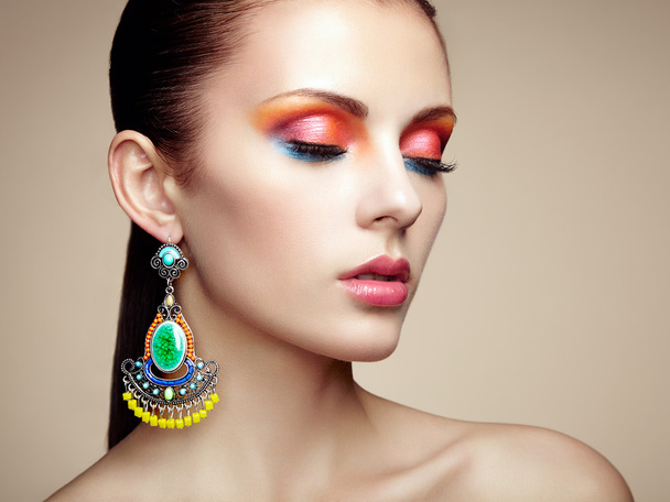 Portrait of beautiful young woman with earring. Jewelry and acce - Фото, зображення