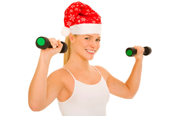 Woman with Santa Hat lifts weights - Фото, изображение