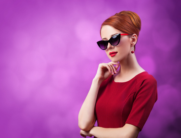 Beautiful redhead women on viloet background. - Photo, Image