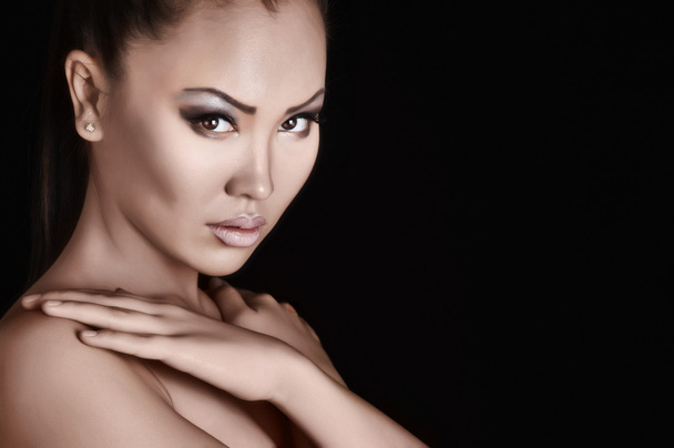 Beautiful asian model on a black background - Photo, Image