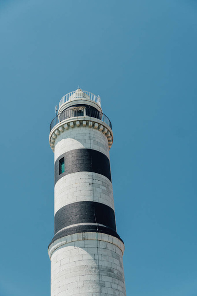 A vertical shot of the Faro di Murano in Venice, Italy during daylight - 写真・画像