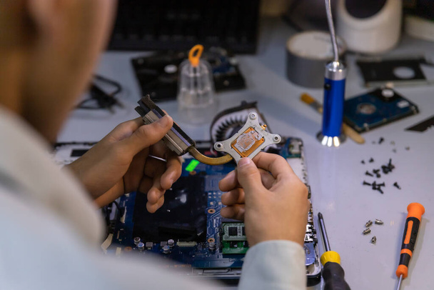 A computer repair technician repairing a laptop - Фото, изображение