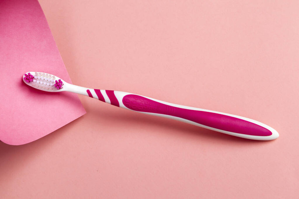 Pink toothbrush on pink background. Copy space. - Photo, image