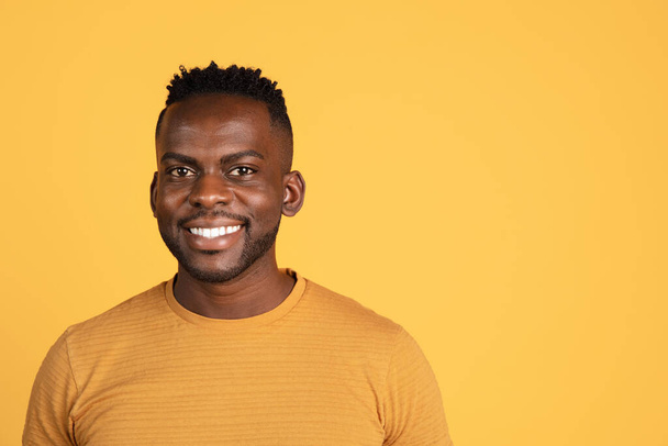 Portrait of African young man in casual clothes isolated on yellow color studio background. Concept of human emotions, facial expression, youth, feelings, ad. - Foto, Bild