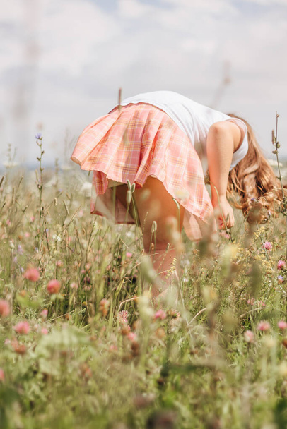 Girl seeking flowers in the fields - Fotó, kép