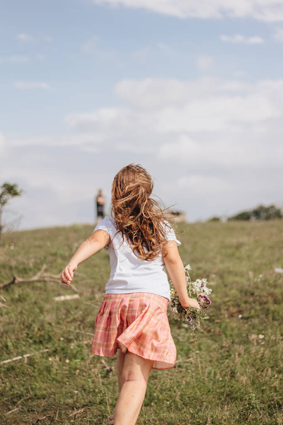 Girl walking in a field in the mountains - Foto, imagen
