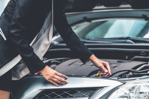 A business woman try to fix the car by herself. - Photo, Image