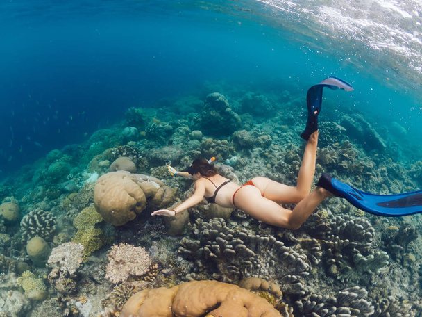 Female extreme swimmer in flippers exploring aquatic oceania depth during getaway adventure on Bali, fit woman wanderer snorkeling in sea during active summer holidays in touristic New Guinea - Photo, Image
