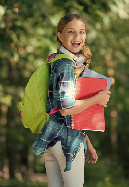 Your education your way. Happy kid carry books and backpack outdoors. School education. Study and schooling. Active learning. Mental development. Casual fashion style. Childhood years - Foto, immagini