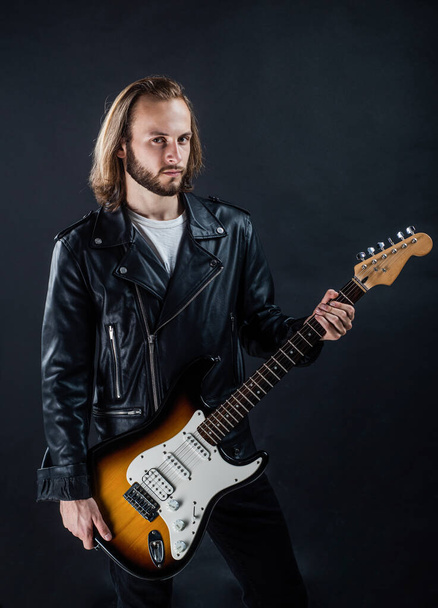 bearded rock musician playing electric guitar in leather jacket, guitar player - Fotoğraf, Görsel