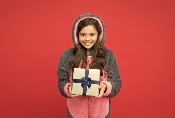 happy teenage girl in rabbit kigurumi pajamas hold present box, happy new year - Photo, Image