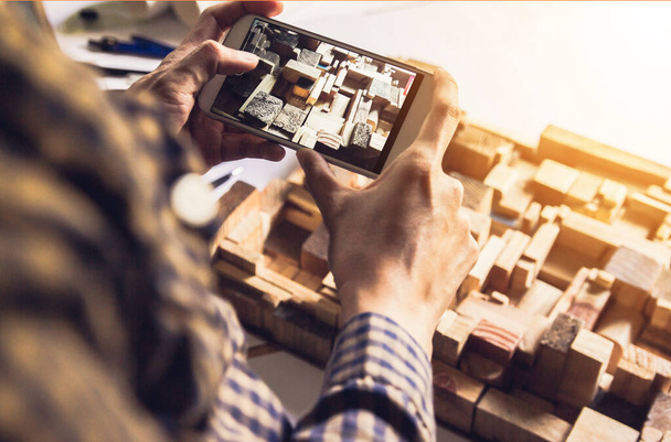 Concept architects,Using digital smartphone shooting, architect hands making model building, house. On the desk with a blueprint in the office, Vintage, Sunset light.Selective Focus - Fotografie, Obrázek